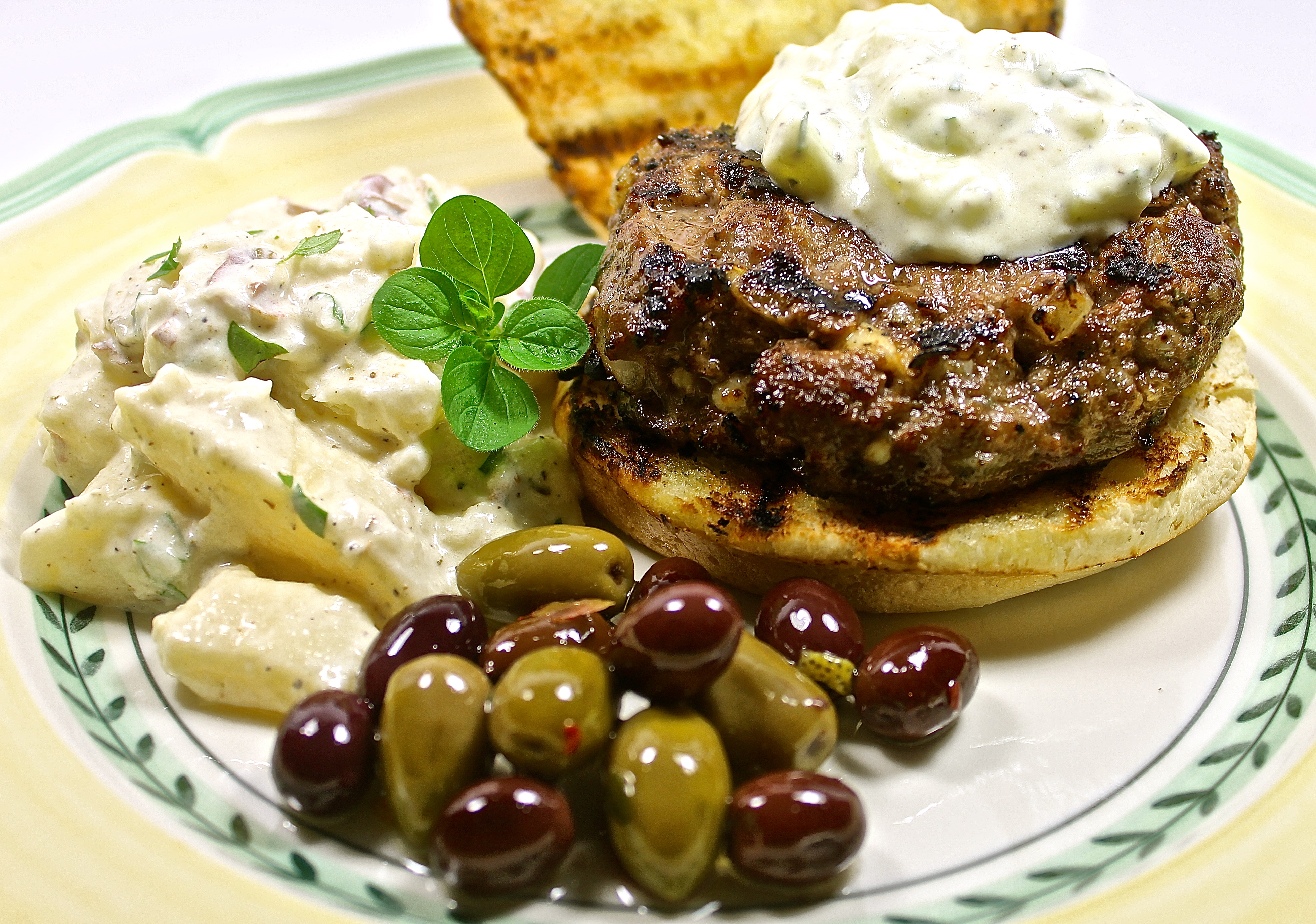 grilled lamb burger with feta tzatziki sauce…seasoned with fresh Greek herbs and lemon served with potato salad and olives