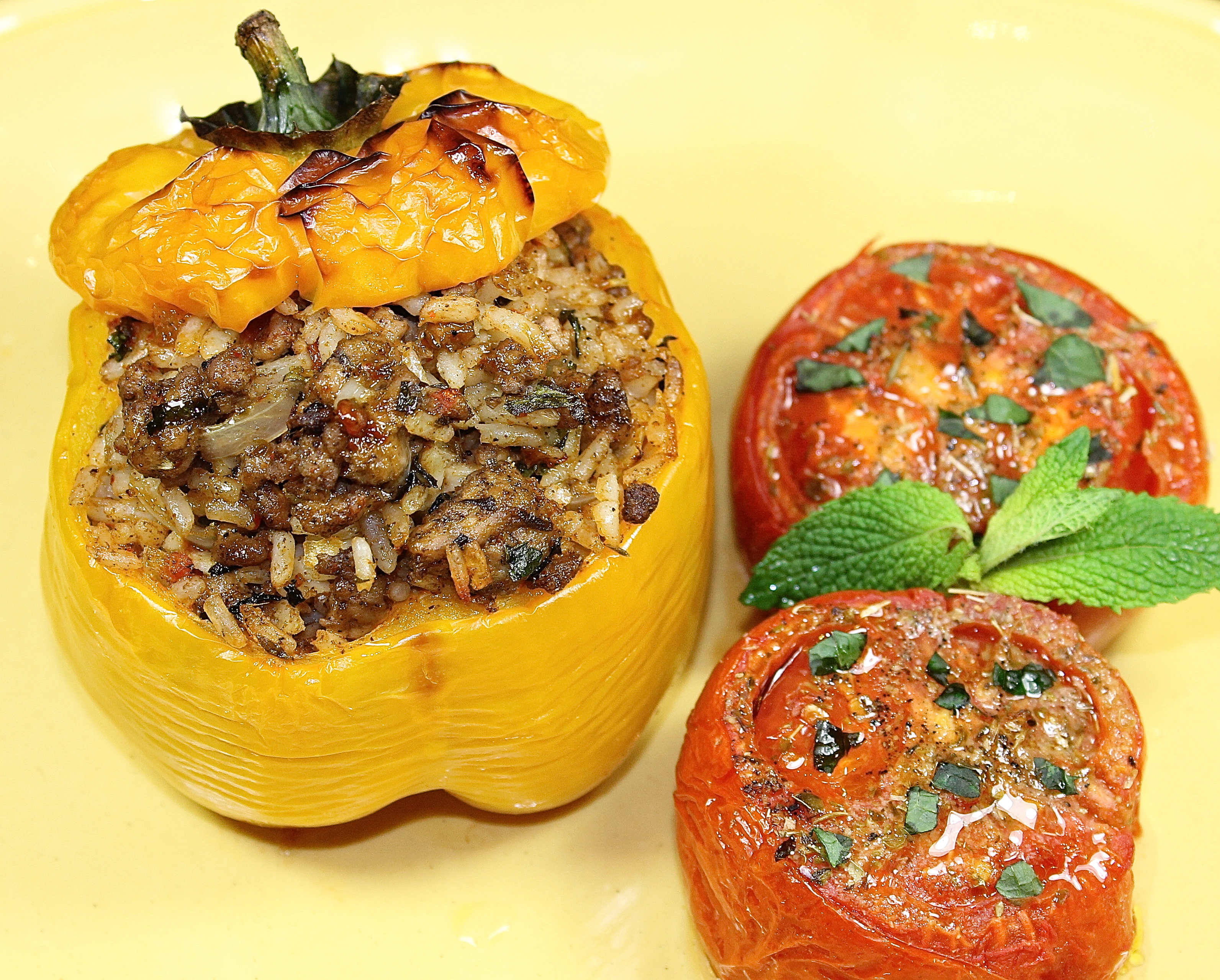 Peppers With A Lamb And Rice Stuffing Served With Oven Roasted Tomatoes