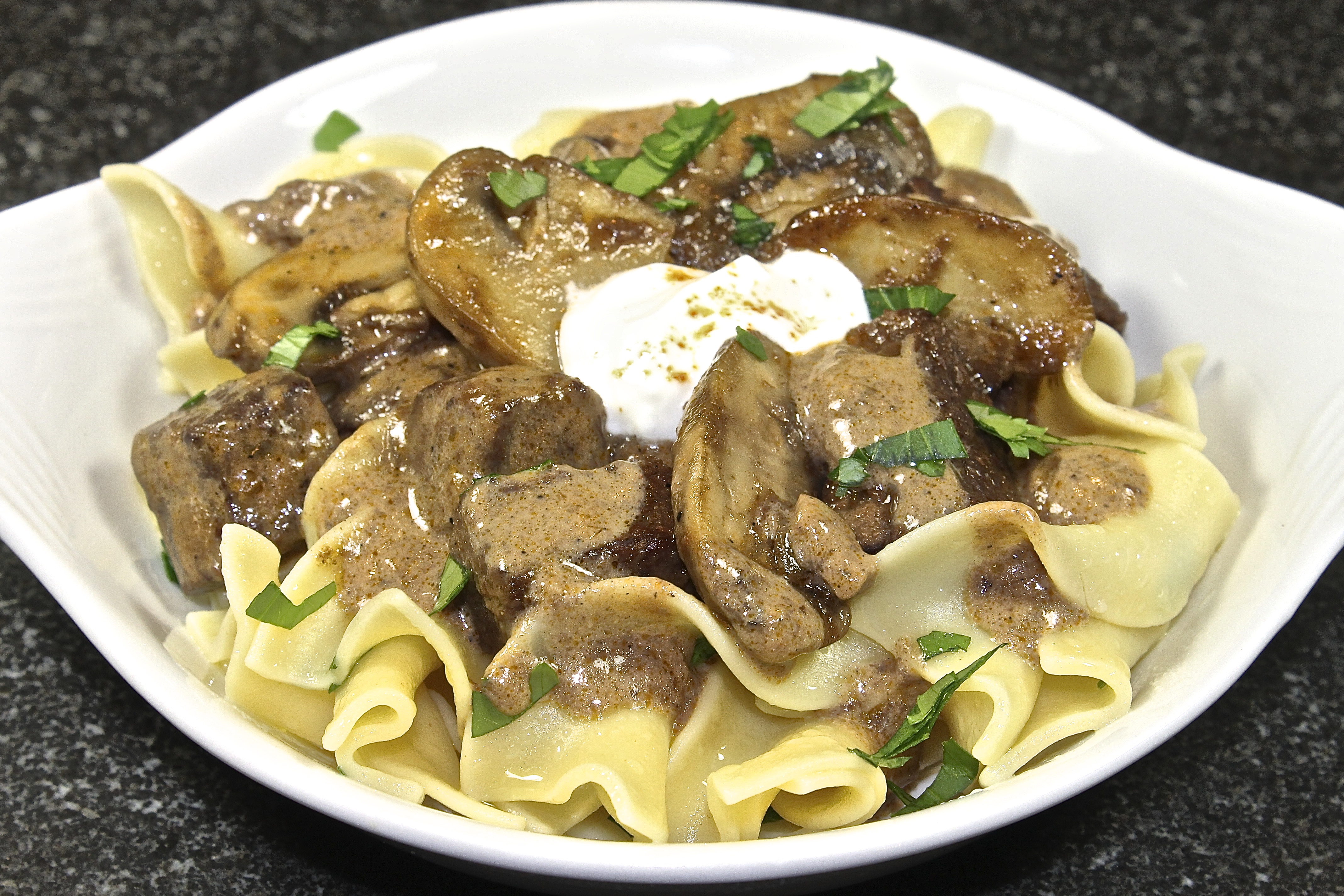 Braised Beef Stroganoff Served Over Buttered Noodles