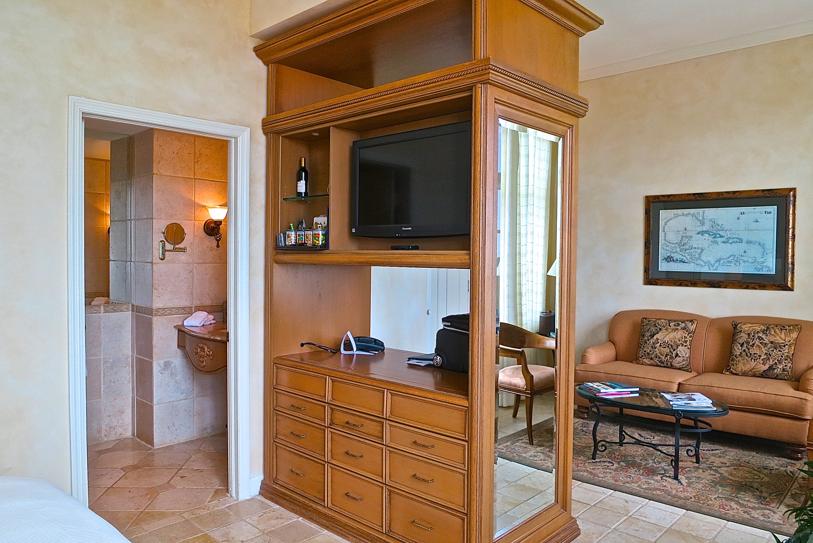 Our Room Had A Sitting Area And King Sized Bed Separated By A Room Divider With TV's, Mini Bar, Drawers And Desk Space