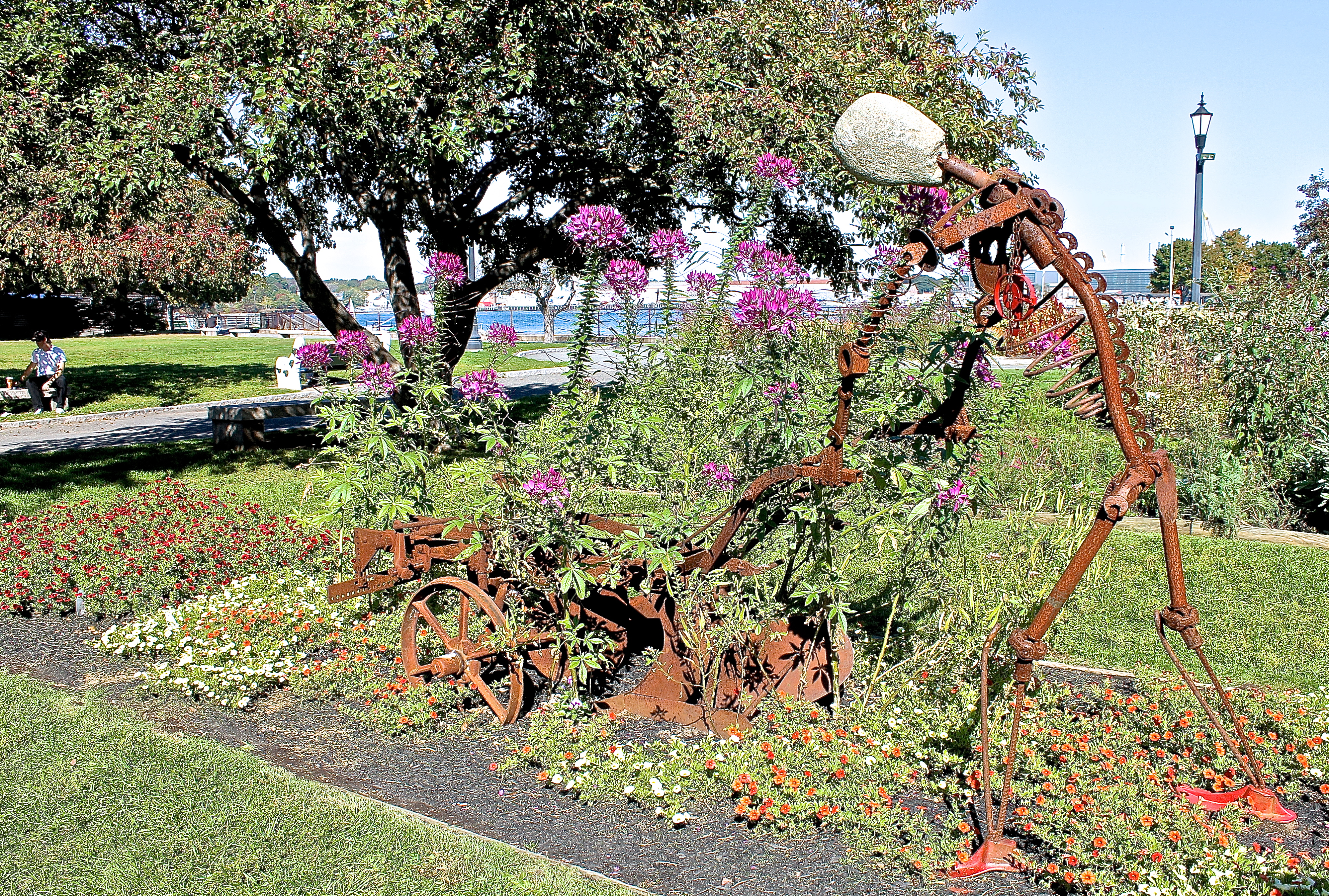 Prescott Park Filled With Flowerbeds, Sculpture and Benches Under The Shade Trees