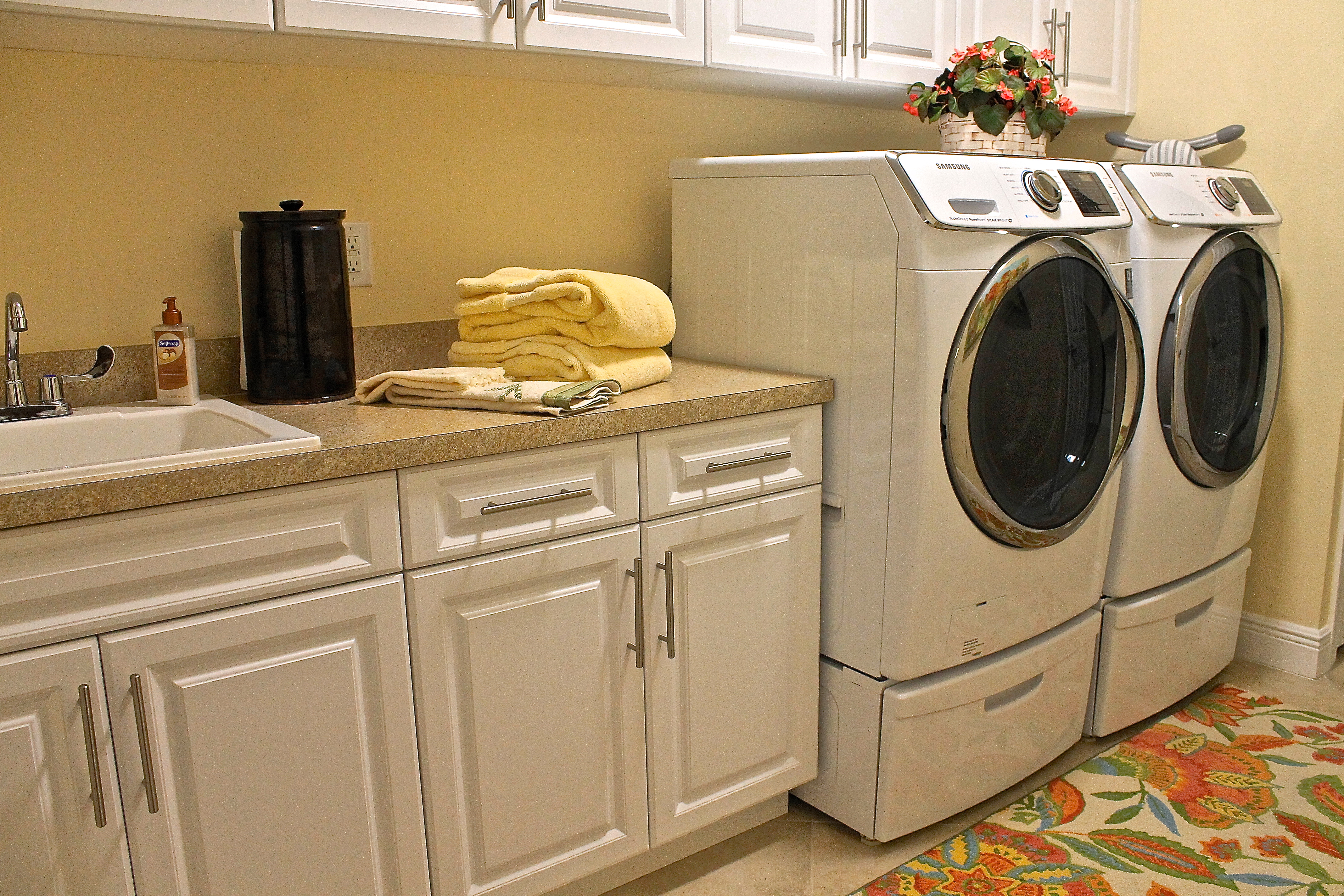 The Washer And Dryer On Pedestals With Drawers To Hold Washing Essentials 