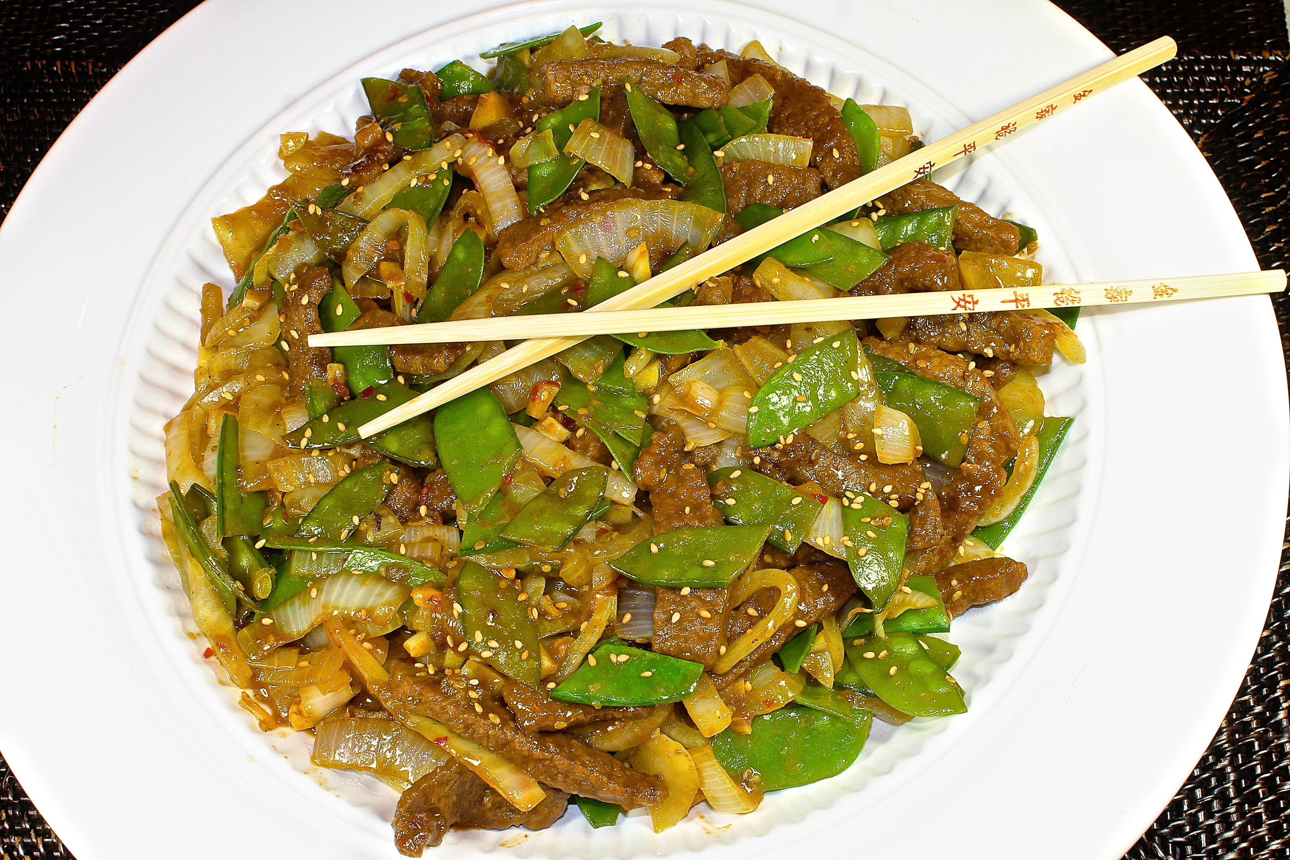 A Large Platter Of Sesame Beef With Snow Peas Ready To Serve Dinner Guests