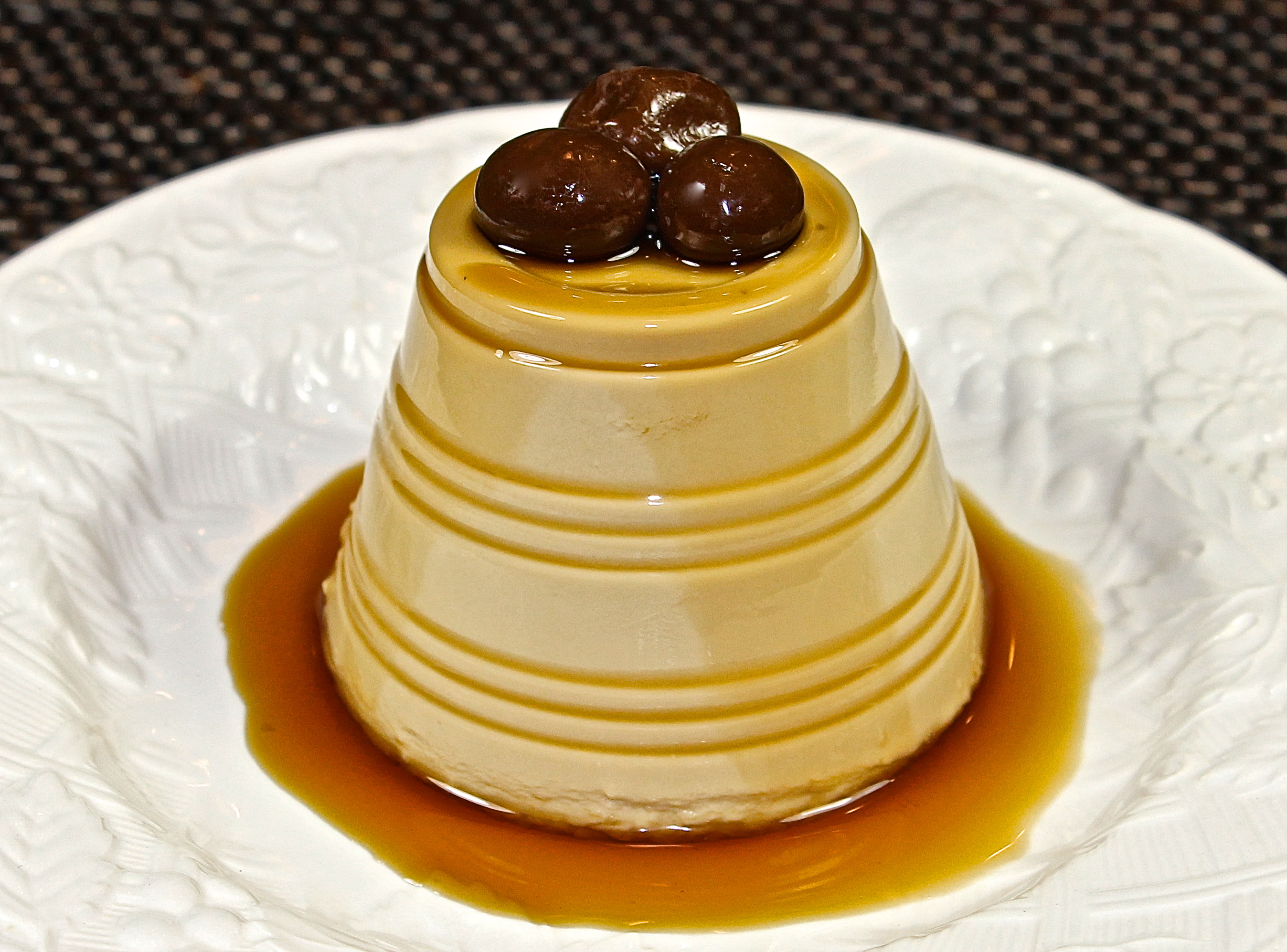 Coffee Panna Cotta Drizzled With Khálua And Topped With Three Dark Chocolate Covered Coffee Beans