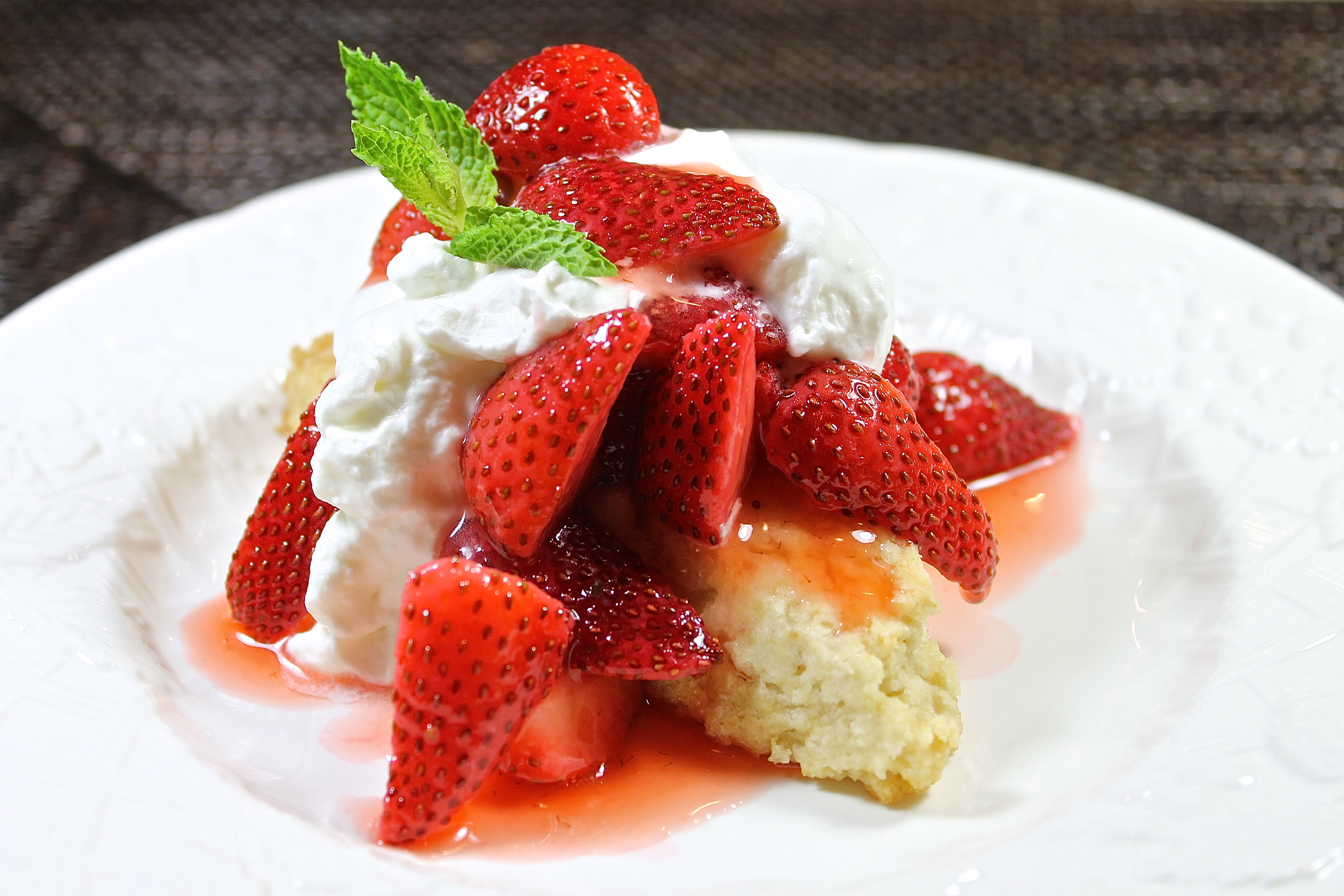 Strawberry Shortcake, the classic summertime dessert, made with sun ripened strawberries piled on top of a buttery shortcake and finished with a large dollop of freshly whipped cream 