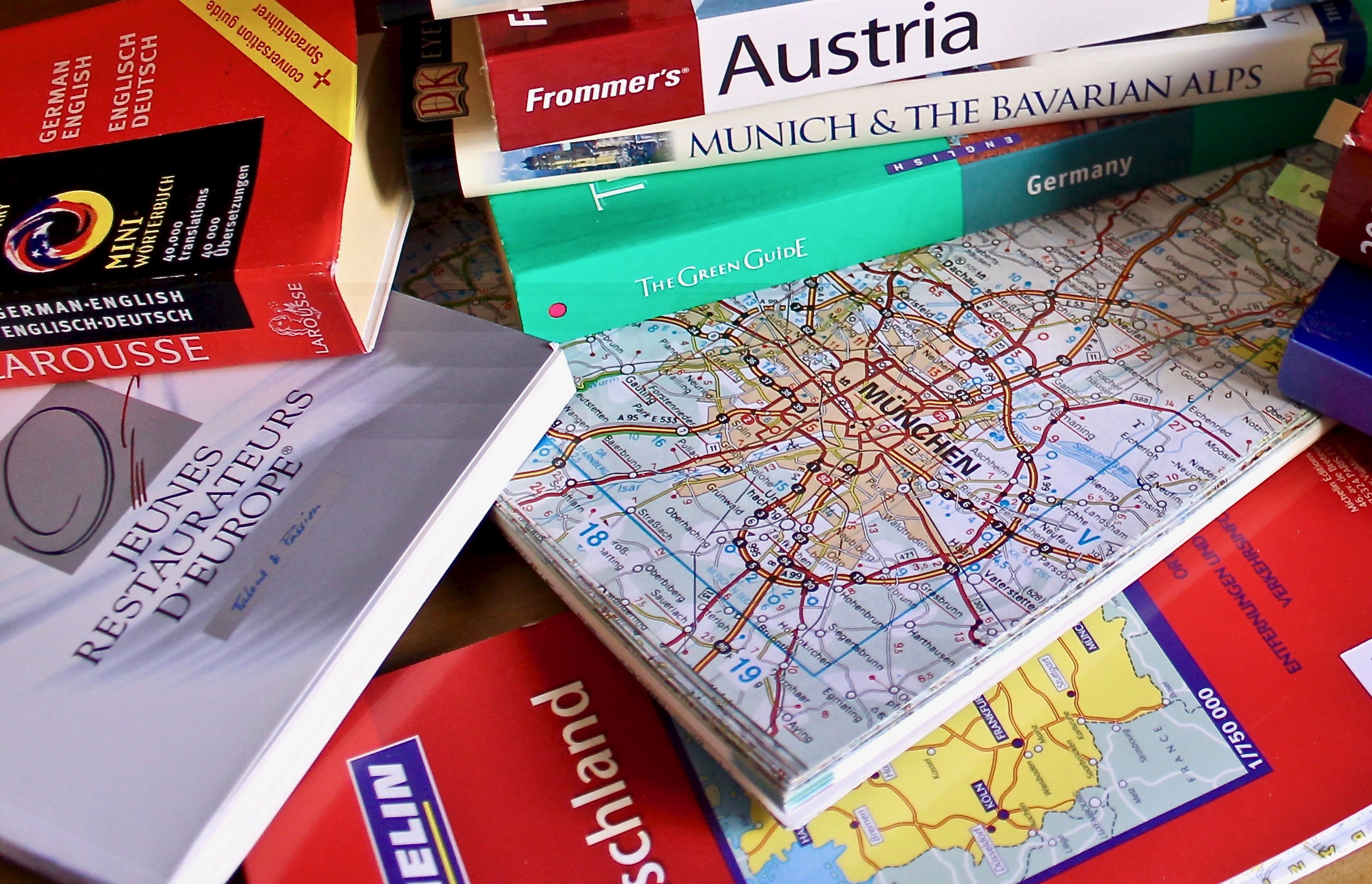 planning a European vacation using travel guidebooks and maps