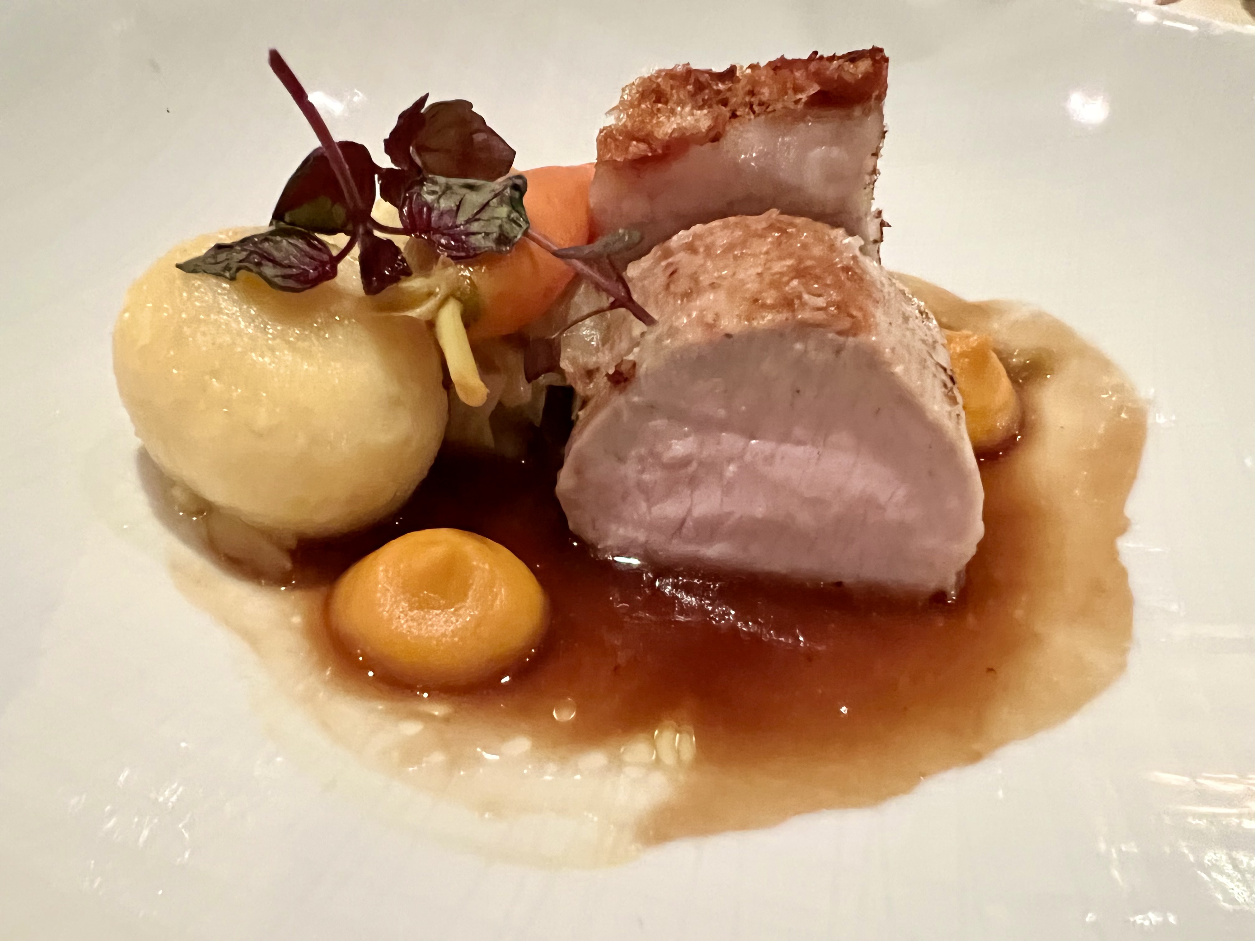 saddle and crispy belly of suckling pig, potato dumpling and white cabbage