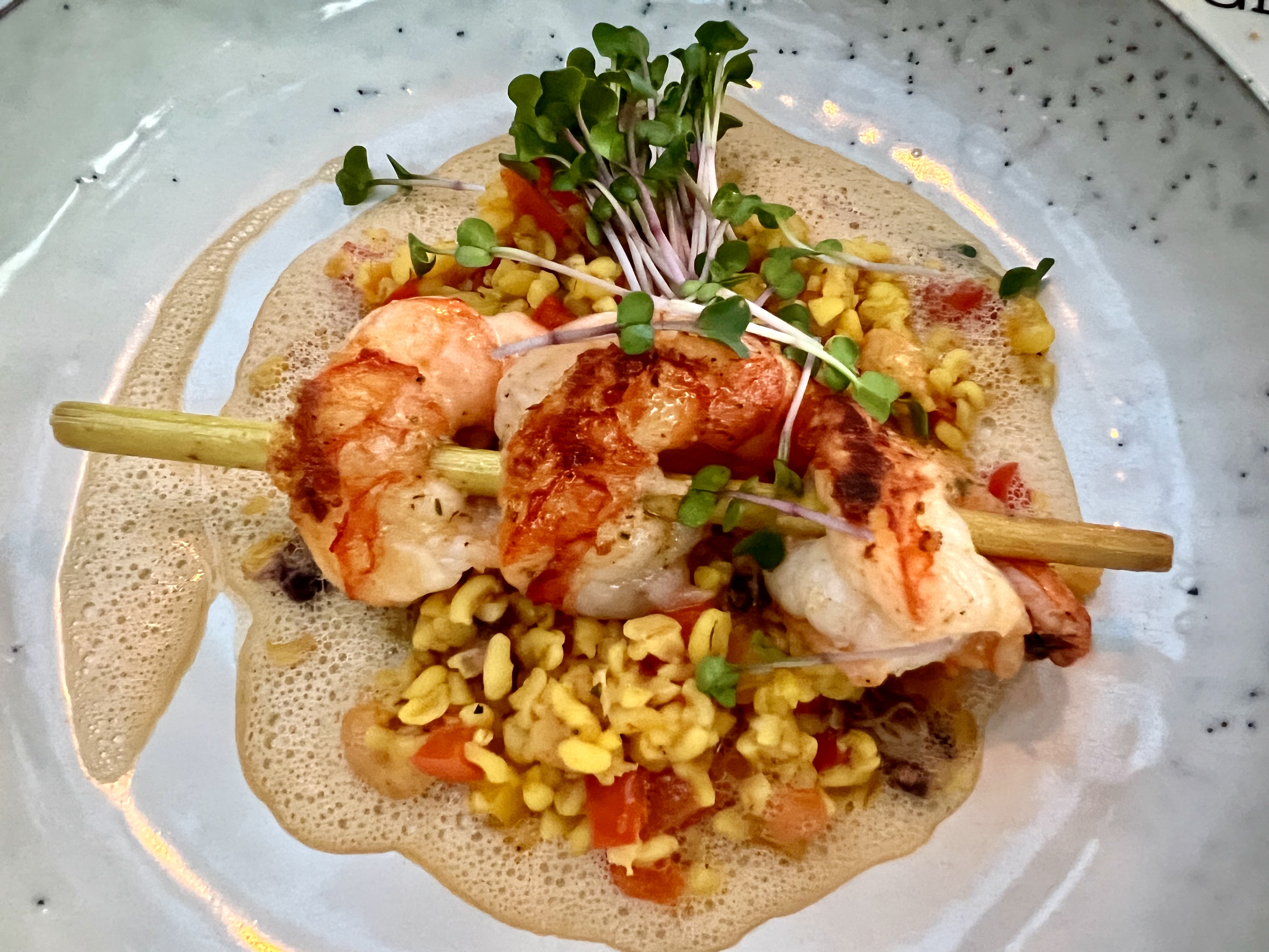 lemongrass shrimp skewer, bulgur paella and lobster butter foam