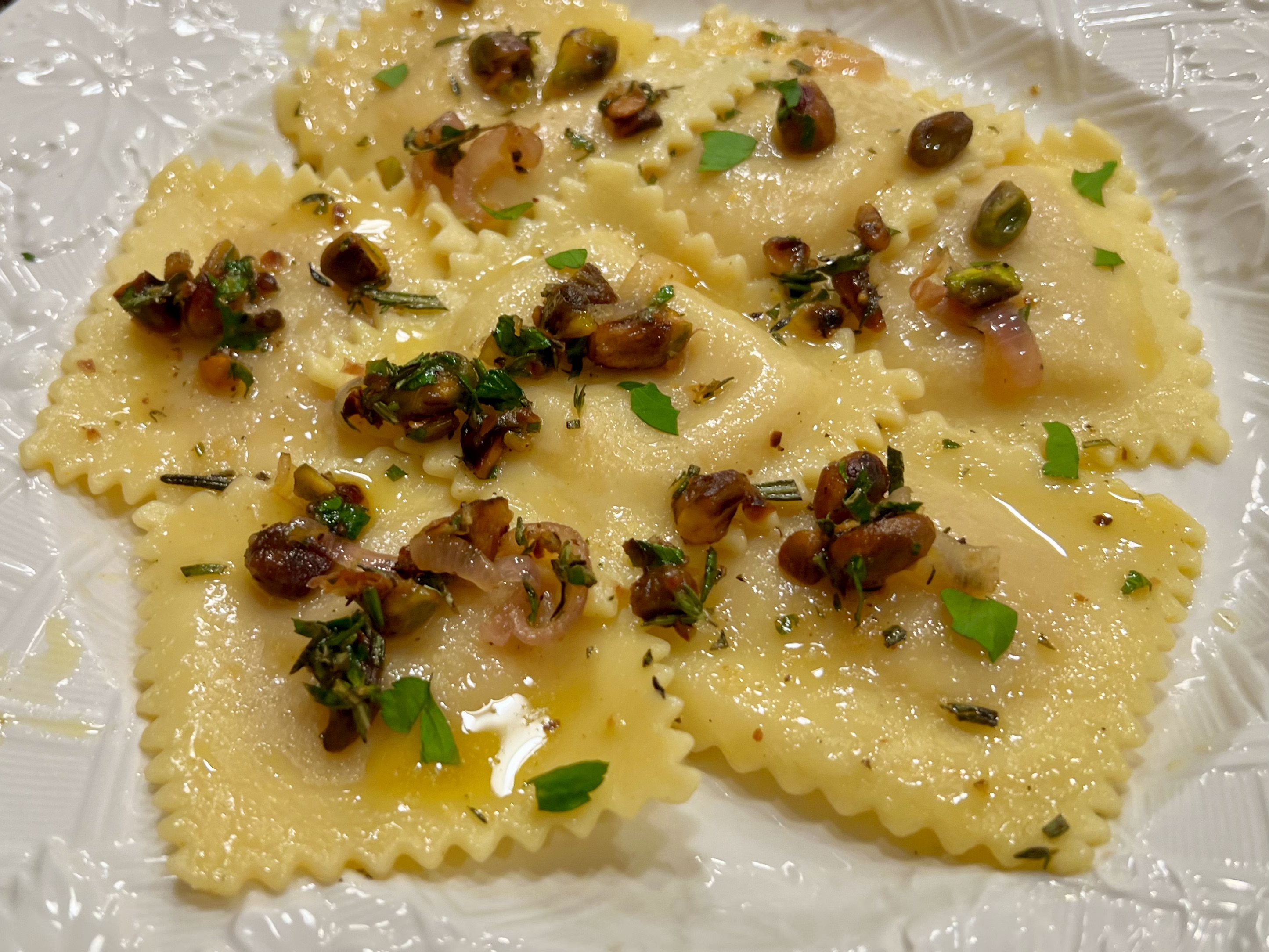 butternut squash ravioli with lemon herb butter and pistachios 