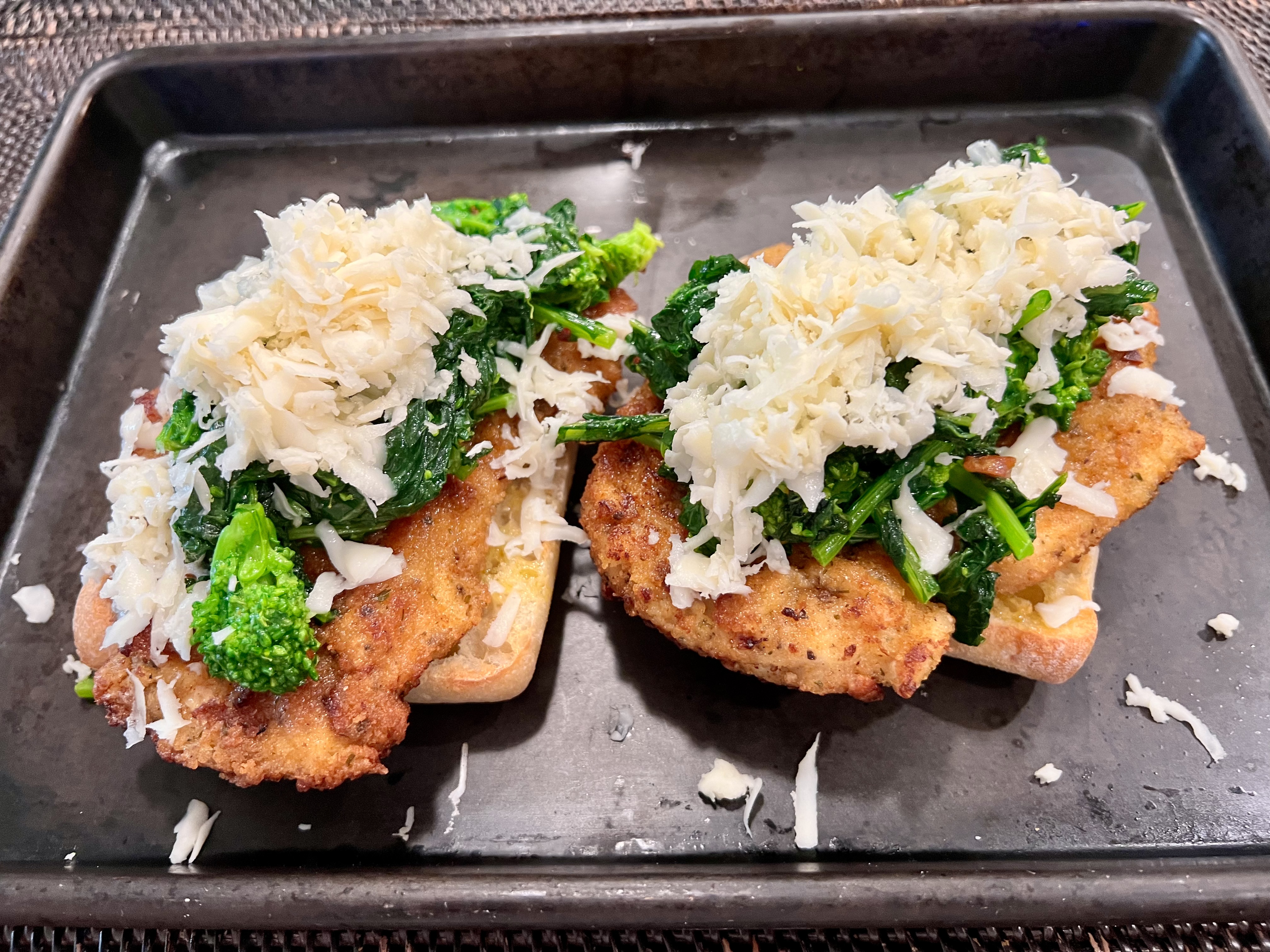assembling a chicken and broccoli rabe sandwich before going in the oven to melt the cheese