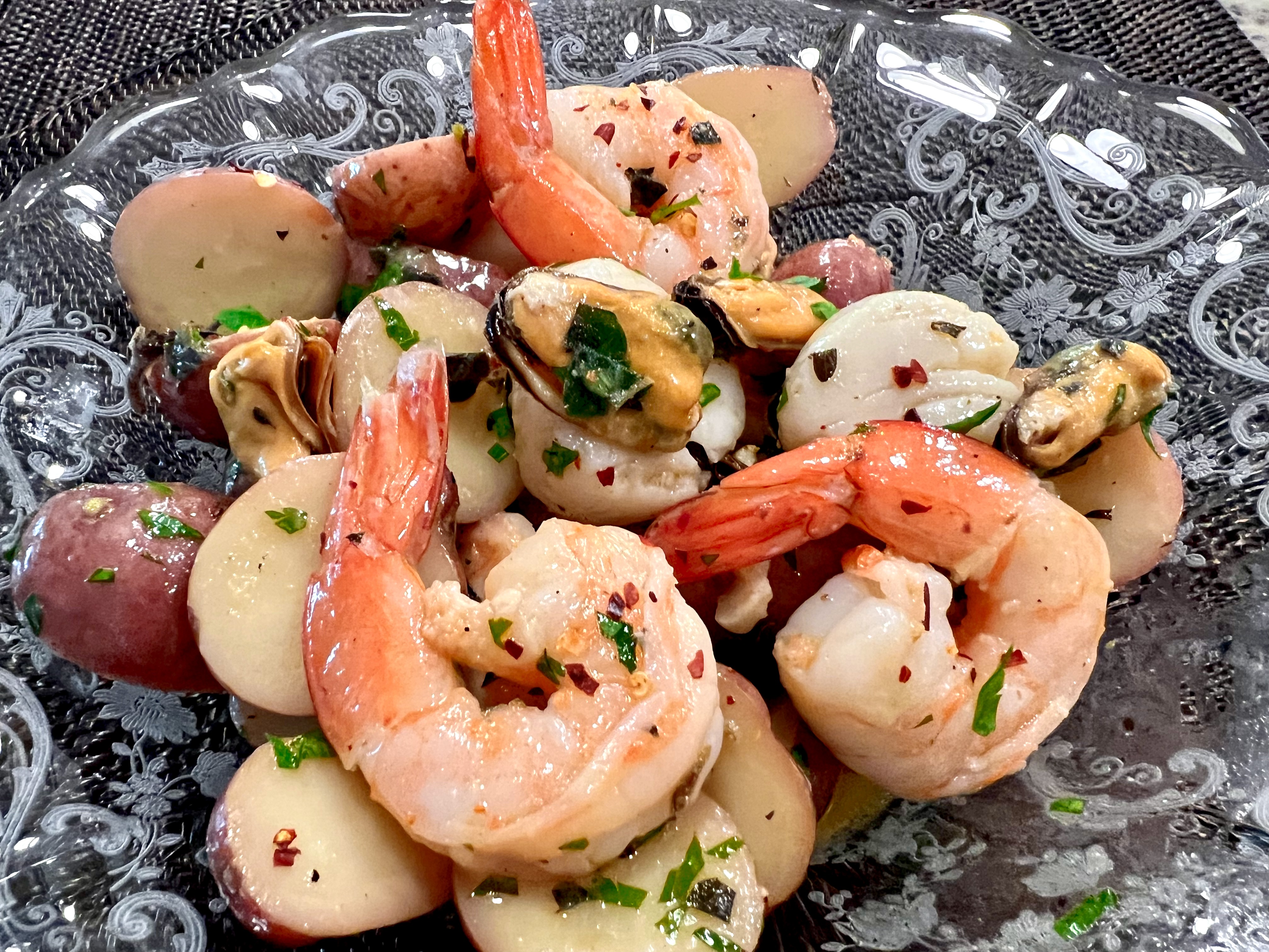 Italian seafood salad is an elegant dinner with plump mussels, sweet shrimp, scallops, and tender red potatoes tossed together with fresh lemon, extra virgin olive oil, and herbs